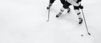 close up of two hockey players on the ice